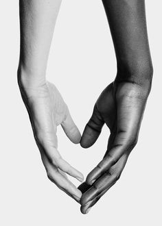 two hands are holding each other in the shape of a heart on a white background