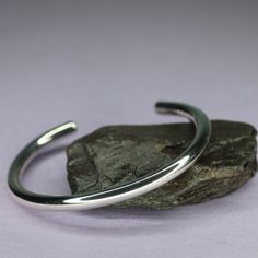 "Beautiful  handcrafted solid sterling silver Men's highly polished design torque bangle. Hand made at my West Yorkshire workshop by myself a fully skilled silversmith with over 25 years experience. All my silver is purchased from a top British bullion supplier and fully hallmarked by the Sheffield assay office. Made from 6mm  solid silver bar Available in 5 different sizes. 7\", 7.5\", 8\", 8.5\", & 9\". DONT BELIEVE THE SELLERS WHO SAY ONE SIZE FITS ALL    NO IT DOESNT! That is why I make many Mens Silver Bangle, Modern Silver Jewelry, Star Bangle, Statement Cuff Bracelet, Silver Bar, Bangle Designs, Black Gift Boxes, West Yorkshire, Sterling Silver Mens