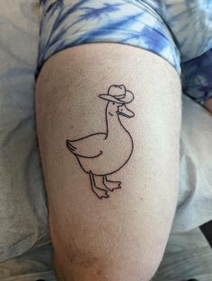 a person with a duck tattoo on their leg