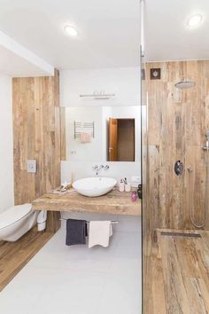 a bathroom with wood paneling and white fixtures