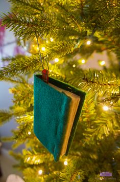 an ornament hanging from the top of a christmas tree