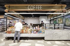 a coffee shop with people standing at the counter