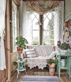 a living room filled with furniture and potted plants