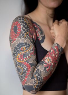 a woman with tattoos on her arms and arm