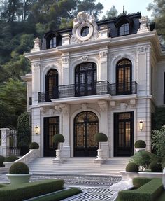 a large white house with black windows and balconies