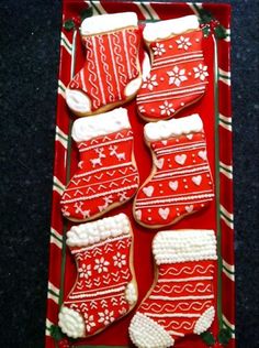 red and white knitted christmas stockings in a box with snowflakes on them