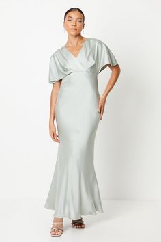 Exquisite satin fabric drapes elegantly for a flattering fishtail silhouette Batwing sleeves add a touch of drama to this sophisticated maxi dress Plunging V-neckline creates a refined and alluring look Fishtail hem provides a striking flared finish Designed with a petite fit for a tailored and feminine shape  Radiate sophistication and elegance at your next wedding or formal occasion in this exquisite satin maxi dress from Coast. The luxurious fabric flows gracefully, while the batwing sleeve