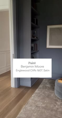 a living room with blue walls and wood floors, painted in farrown moore