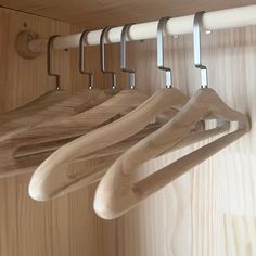 wooden clothes hangers are hanging on the wall