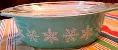 a glass bowl sitting on top of a table covered in snowflake design frosting