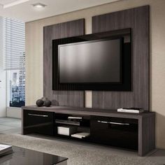 an entertainment center with a flat screen tv mounted on the wall