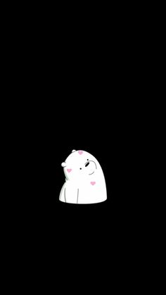 a white polar bear sitting in the dark