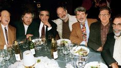 a group of men sitting around a dinner table