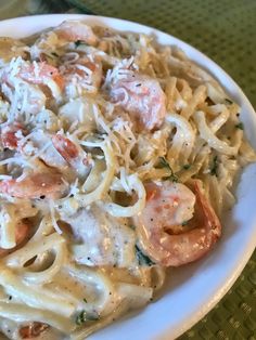 a plate of pasta with shrimp and cheese