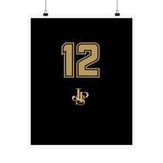 a black and gold poster with the number twelve on it's front, hanging from two