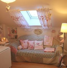 a living room filled with furniture and a skylight over the window above it's windowsill