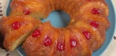 two pineapple upside down cakes on a blue plate