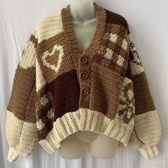 a white mannequin wearing a brown and white knitted sweater with hearts on it