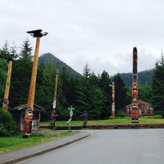 the road is lined with totem poles and signs