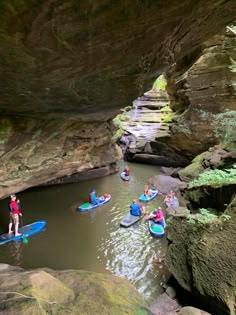 several people in kayaks paddling through a cave