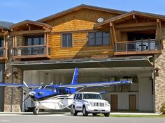 an airplane parked in front of a large house