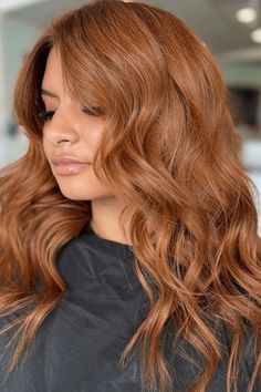 This sumptuous brown ginger hairdo radiates warmth and depth with its vibrant, fiery hues that blend harmoniously, creating a sun-kissed aesthetic. Cascading in soft, voluminous waves, the hair has been styled to accentuate its natural flow and movement, beautifully framing the wearer's features. The - Click to see more of Embrace Your Ginger Charm: 40 Captivating Brown Ginger Hair Styles to Elevate Your Look and follow us for more hairstyle ideas. // Photo Credit: Instagram @sleeksocietysalon Ginger Hair Before And After, Low Maintenance Ginger Hair, Soft Autumn Red Hair, Ginger Ombre Hair, Golden Ginger Hair, Ginger Spice Hair, Soft Copper Hair, Light Ginger Brown Hair, Ginger Hair Styles