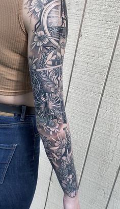 a woman's arm with flowers and an alarm clock tattoo on her left arm