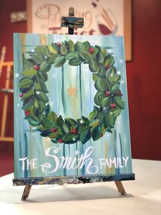 an easel with a painting of a wreath on it