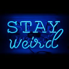 a neon sign that says stay weird