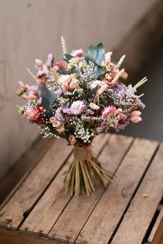 a bouquet of flowers sitting on top of a wooden table