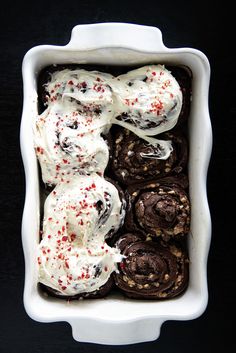 an ice cream sundae with cookies and sprinkles in a white dish