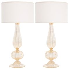 two clear glass lamps with white shades