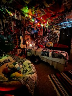 two beds in a room with colorful lights on the ceiling and posters hanging above them