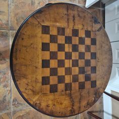 a wooden chess board mounted to the side of a wall