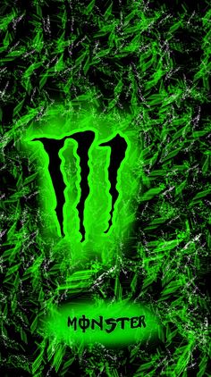 the monster logo is glowing green in front of black and white background with some grass