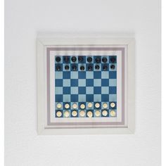 a blue and white chess board mounted on the wall