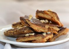 a white plate topped with cookies covered in chocolate