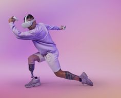 a man in purple shirt and knee braces holding a tennis racquet on pink background