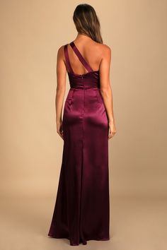 the back of a woman wearing a long purple dress with one shoulder and straps on it