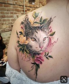 a woman with a cat tattoo on her back