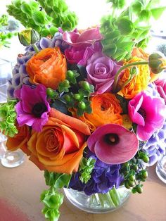 a vase filled with colorful flowers on top of a table