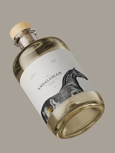 a bottle of wine with an image of a horse on the label is shown in front of a gray background