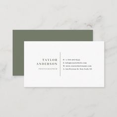 a business card with the words taylor and anderson in gold on it, sitting on a marble surface