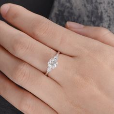 a woman's hand with a diamond ring on it