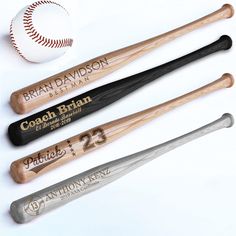 three baseball bats and a ball on a white table top with the names of each team