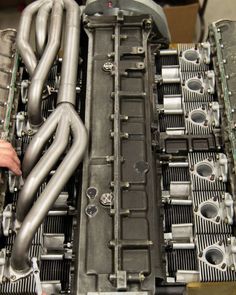 a close up view of the front end of a car engine with pipes and piping