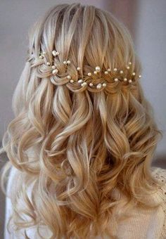 the back of a woman's head with long blonde hair and pearls on it