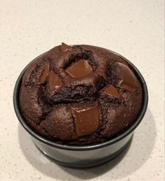 a chocolate cookie in a metal bowl on a counter