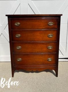 an old dresser with brass pulls and knobs on it's drawers is shown in front of a garage door