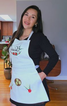 a woman in an apron posing for the camera